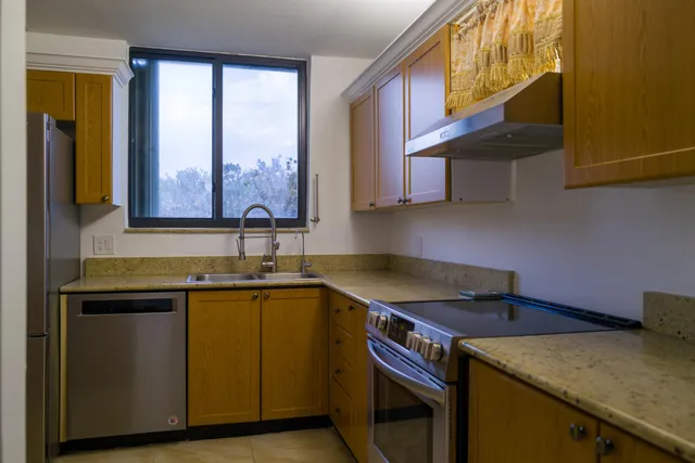 a kitchen with a sink cabinets and a window