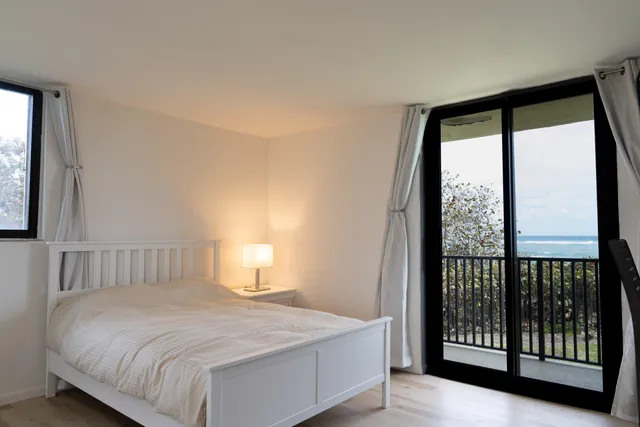 a bedroom with a large bed and a large window