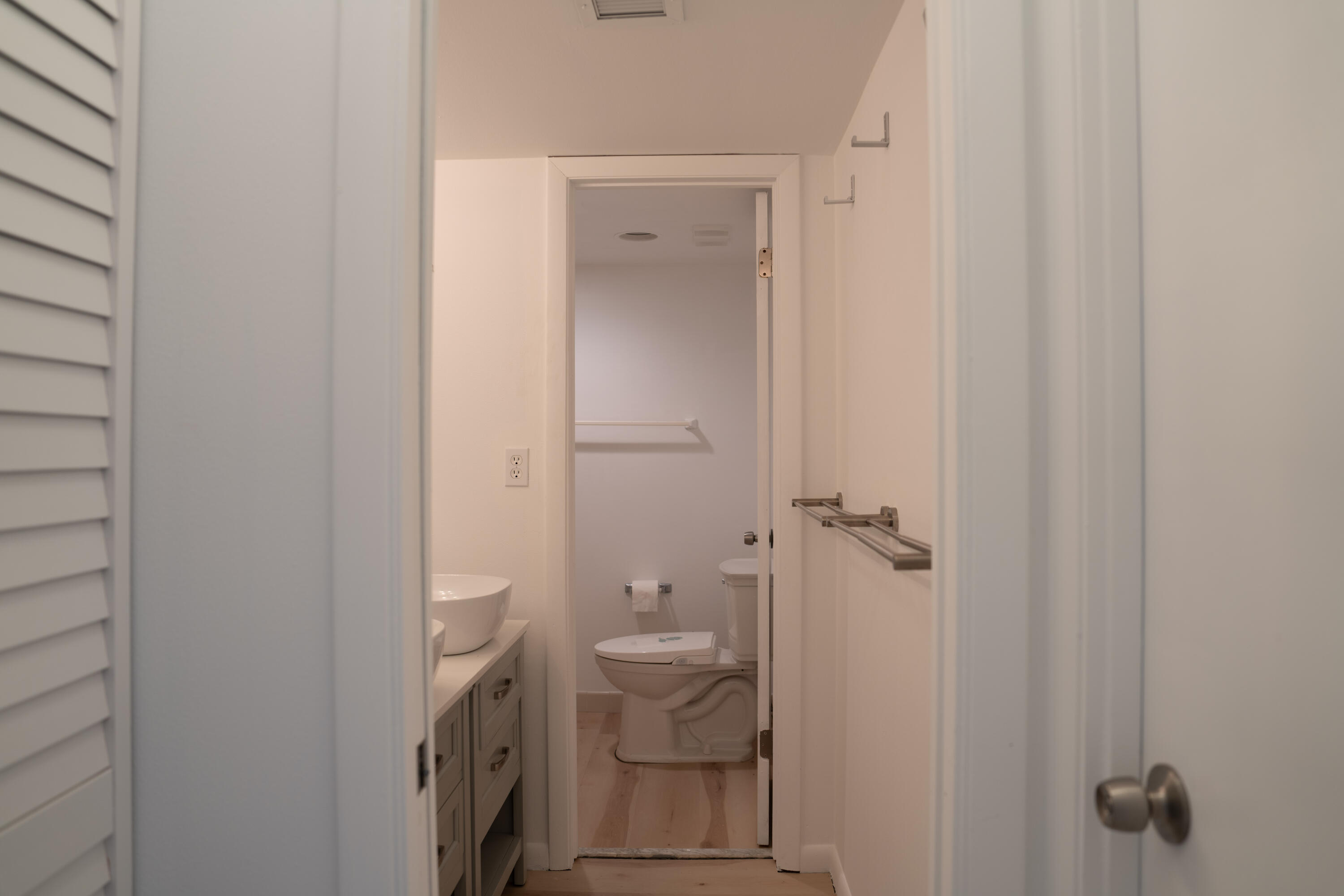 400 Ocean Trail Way, Unit 101 Jupiter, FL 33477 - Photo 16 of 21 a bathroom with a granite countertop sink a toilet and shower