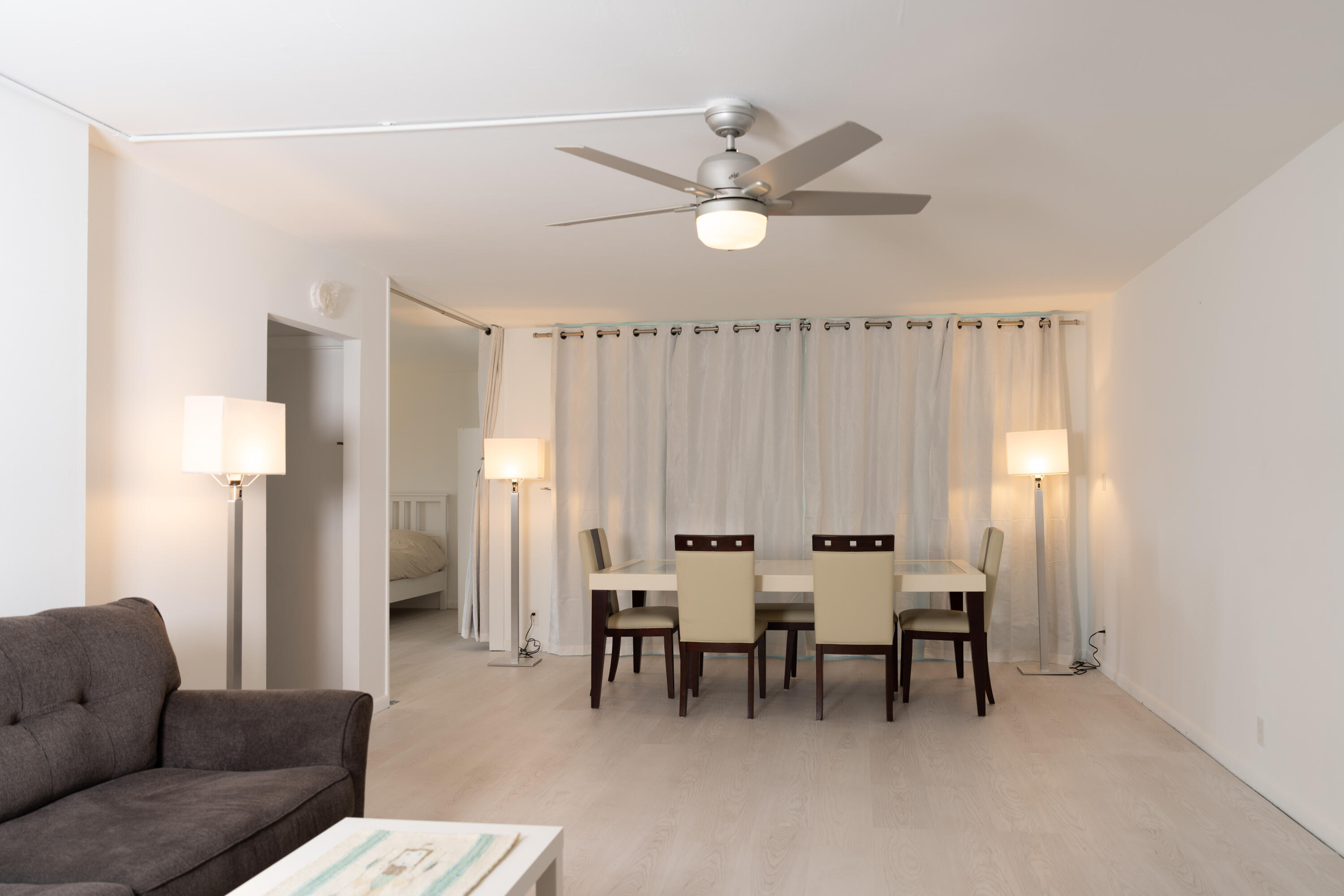 400 Ocean Trail Way, Unit 101 Jupiter, FL 33477 - Photo 8 of 21 a living room with furniture and a chandelier