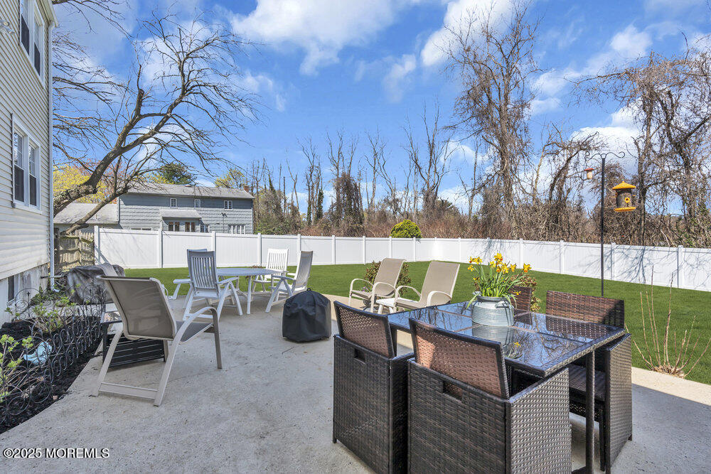 4 Koosman Drive Middletown, NJ 07737 - Photo 21 of 27 a view of a patio with table and chairs and potted plants