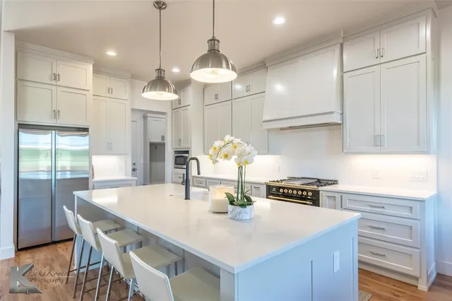 a kitchen with kitchen island a dining table and chairs