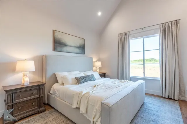 a bedroom with a bed and a lamp