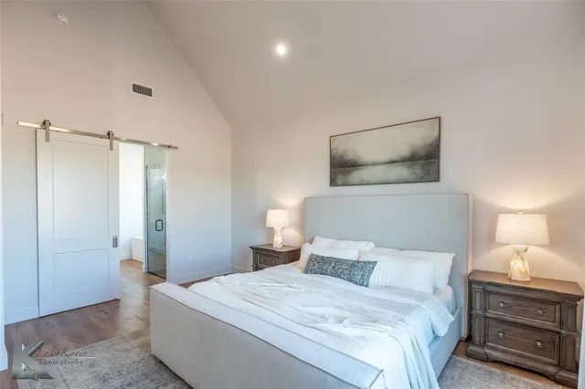 a bedroom with a bed and a lamp