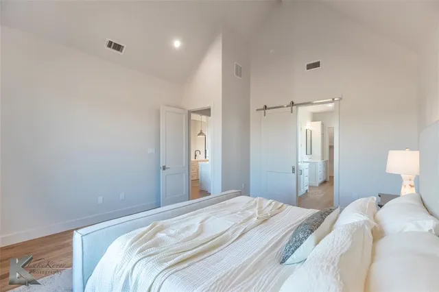 a bedroom with a bed and a lamp