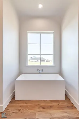 a view of wooden floor and window in an empty room