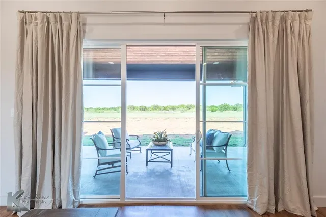 a view of a living room and balcony
