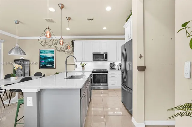 a kitchen with a sink appliances and cabinets