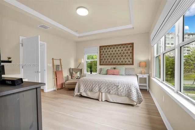 a bedroom with a bed and a large window