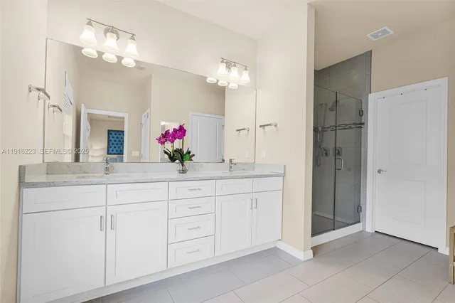 a bathroom with a double vanity sink and a mirror