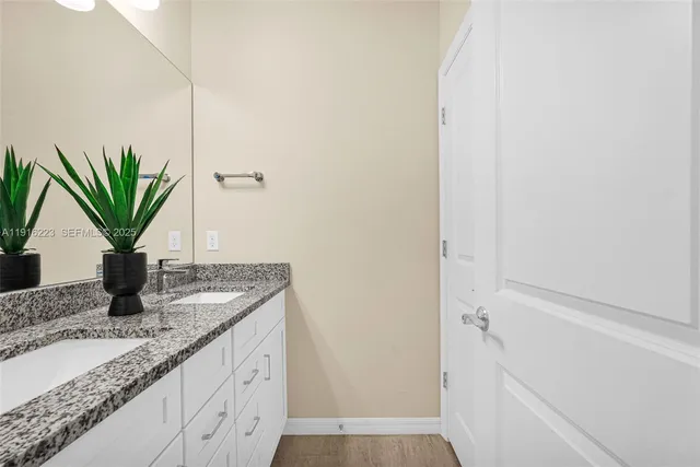 a bathroom with a granite countertop sink and a granite top