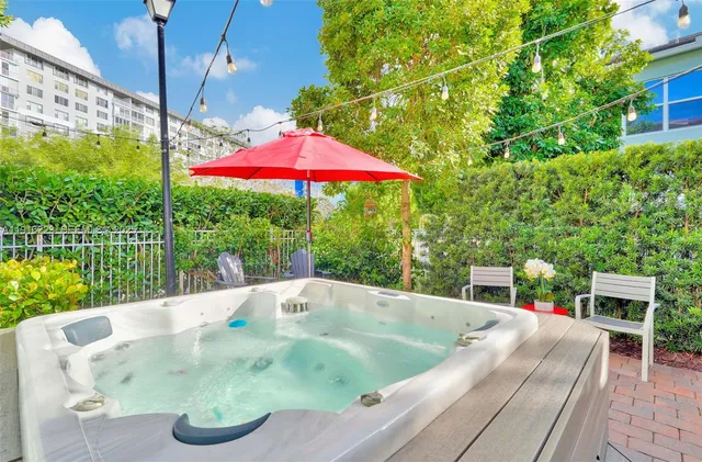 swimming pool view with a seating space