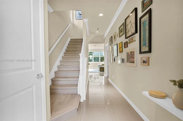 a view of entryway and hall with wooden floor