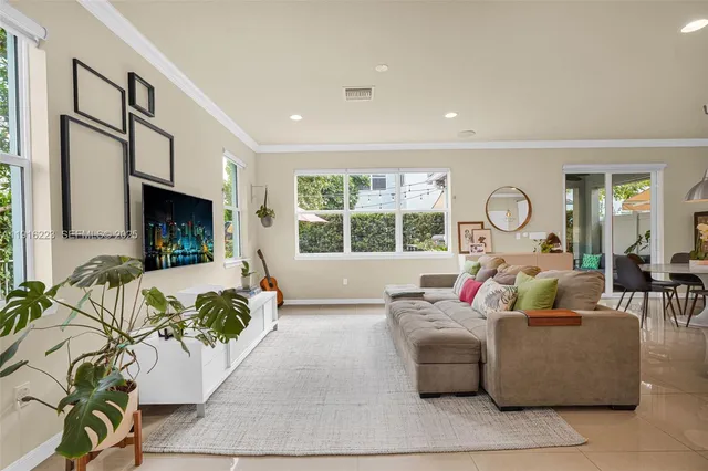 a living room with fireplace furniture and a large window