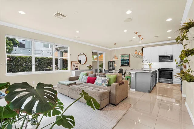 a living room with fireplace furniture and a large window