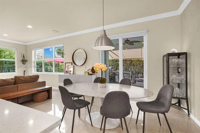 a dining room with furniture a chandelier and wooden floor