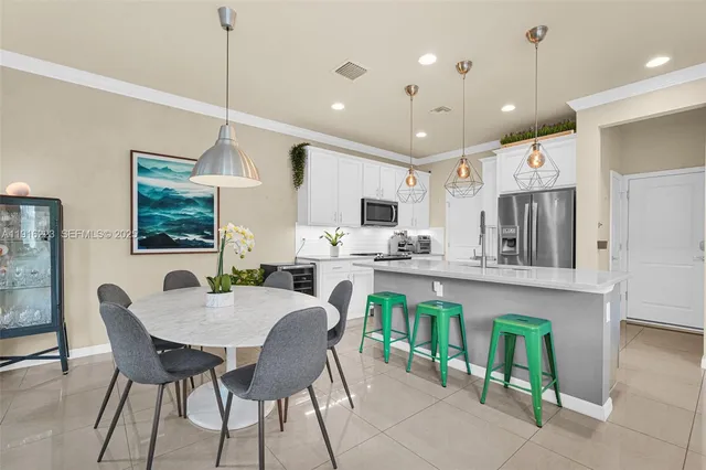 a dining room with furniture a window and kitchen view