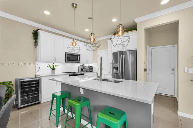 a kitchen with cabinets and chairs