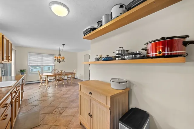 a room with furniture and a view of kitchen