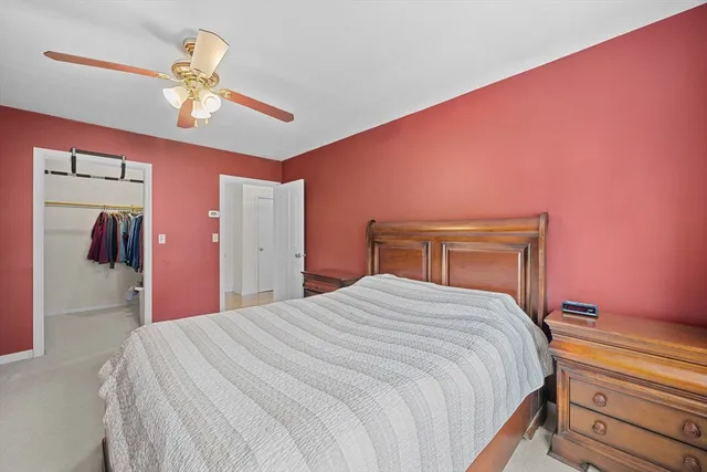 a bedroom with a large bed and a chandelier