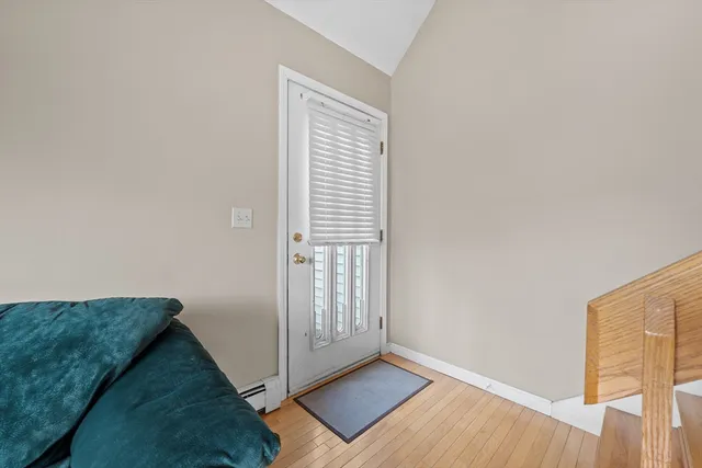 a view of an empty room and wooden floor