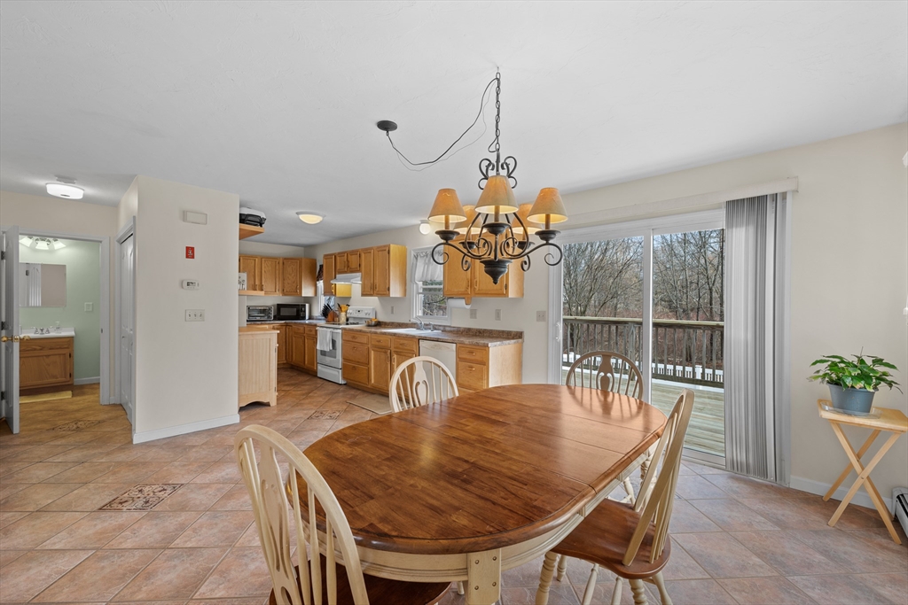 23 Orono Street Worcester, MA 01606 - Photo 8 of 29 a view of a dining room and livingroom with furniture wooden floor a chandelier