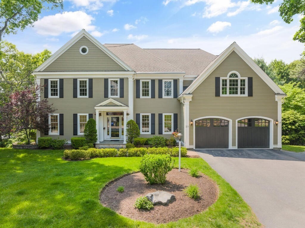 a front view of a house with a garden and plants