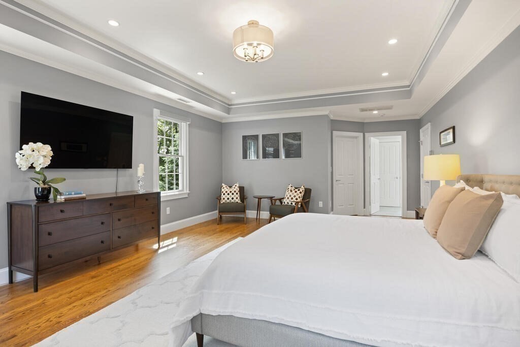 23 Richard Road Lexington, MA 02421 - Photo 16 of 42 a bedroom with a bed and a flat screen tv