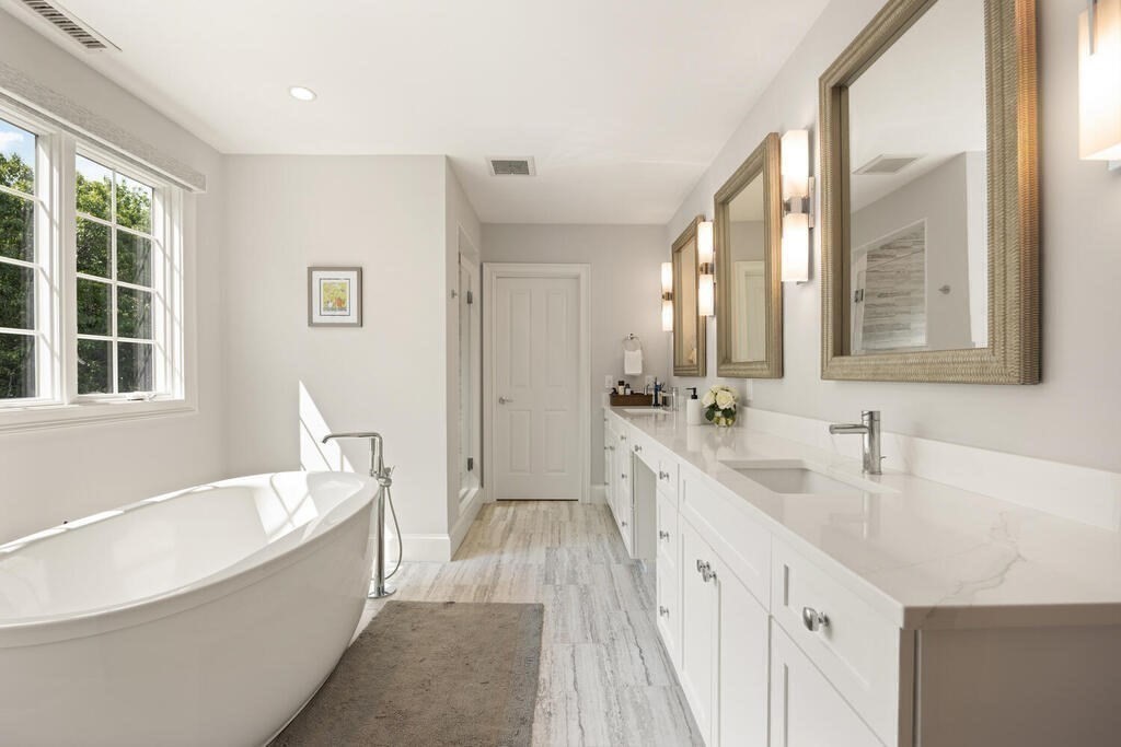 23 Richard Road Lexington, MA 02421 - Photo 18 of 42 a spacious bathroom with a double vanity sink a mirror and a bathtub