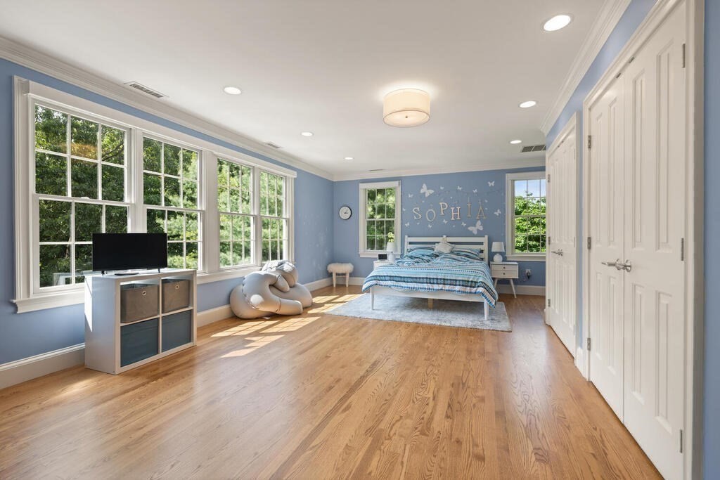 23 Richard Road Lexington, MA 02421 - Photo 19 of 42 a living room with stainless steel appliances furniture large windows and wooden floor