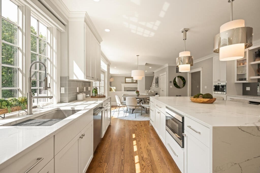 23 Richard Road Lexington, MA 02421 - Photo 8 of 42 a large kitchen with kitchen island a large counter top a sink a stove and a refrigerator
