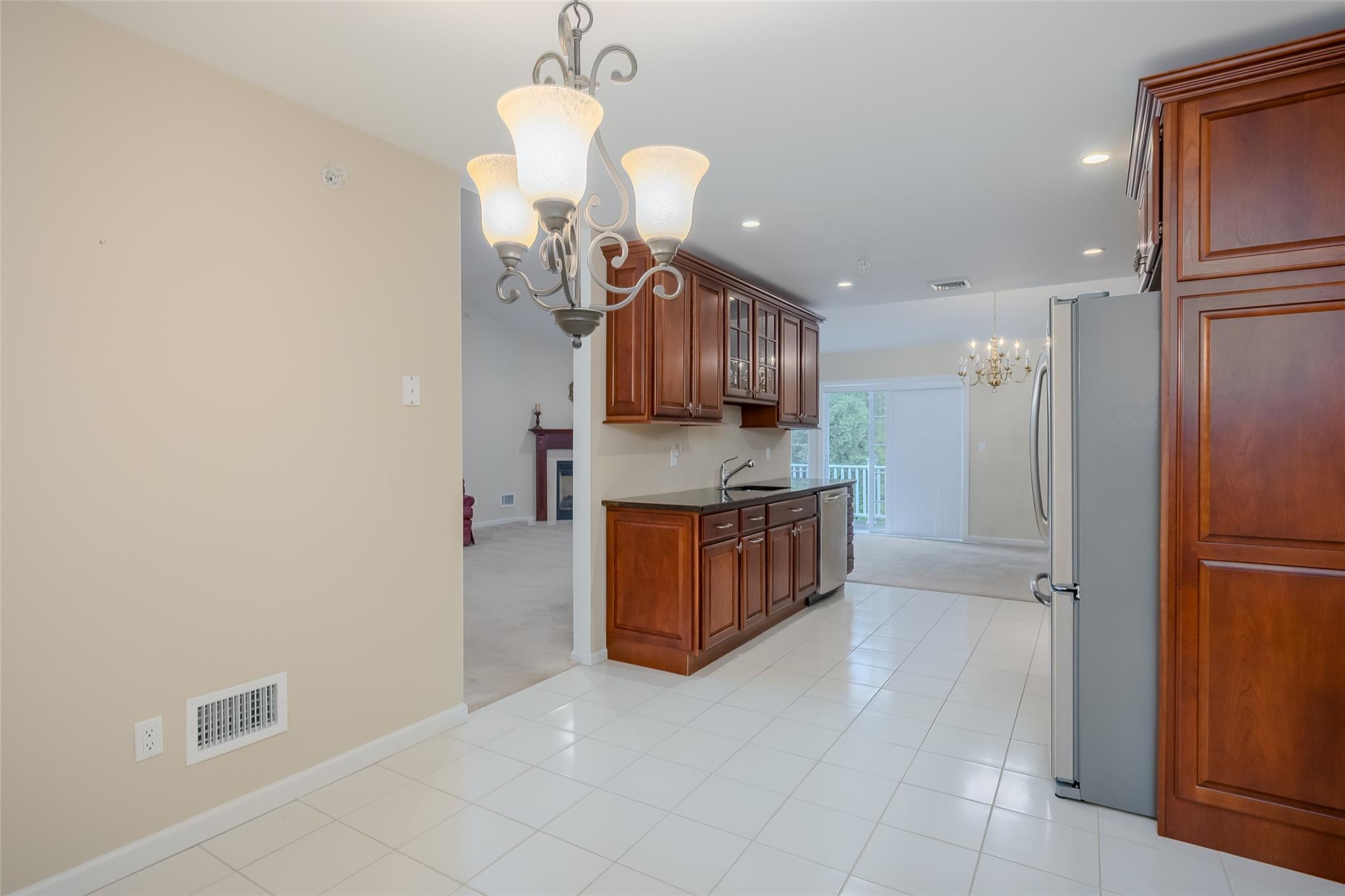 166 Ira Road Mount Sinai, NY 11766 - Photo 14 of 37 a kitchen with stainless steel appliances granite countertop a refrigerator and a sink