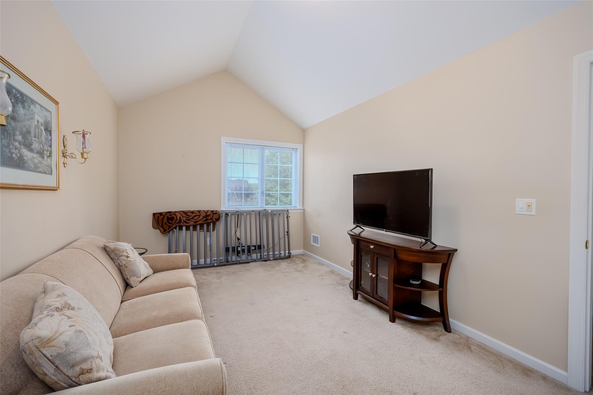 166 Ira Road Mount Sinai, NY 11766 - Photo 20 of 37 a living room with furniture and a flat screen tv