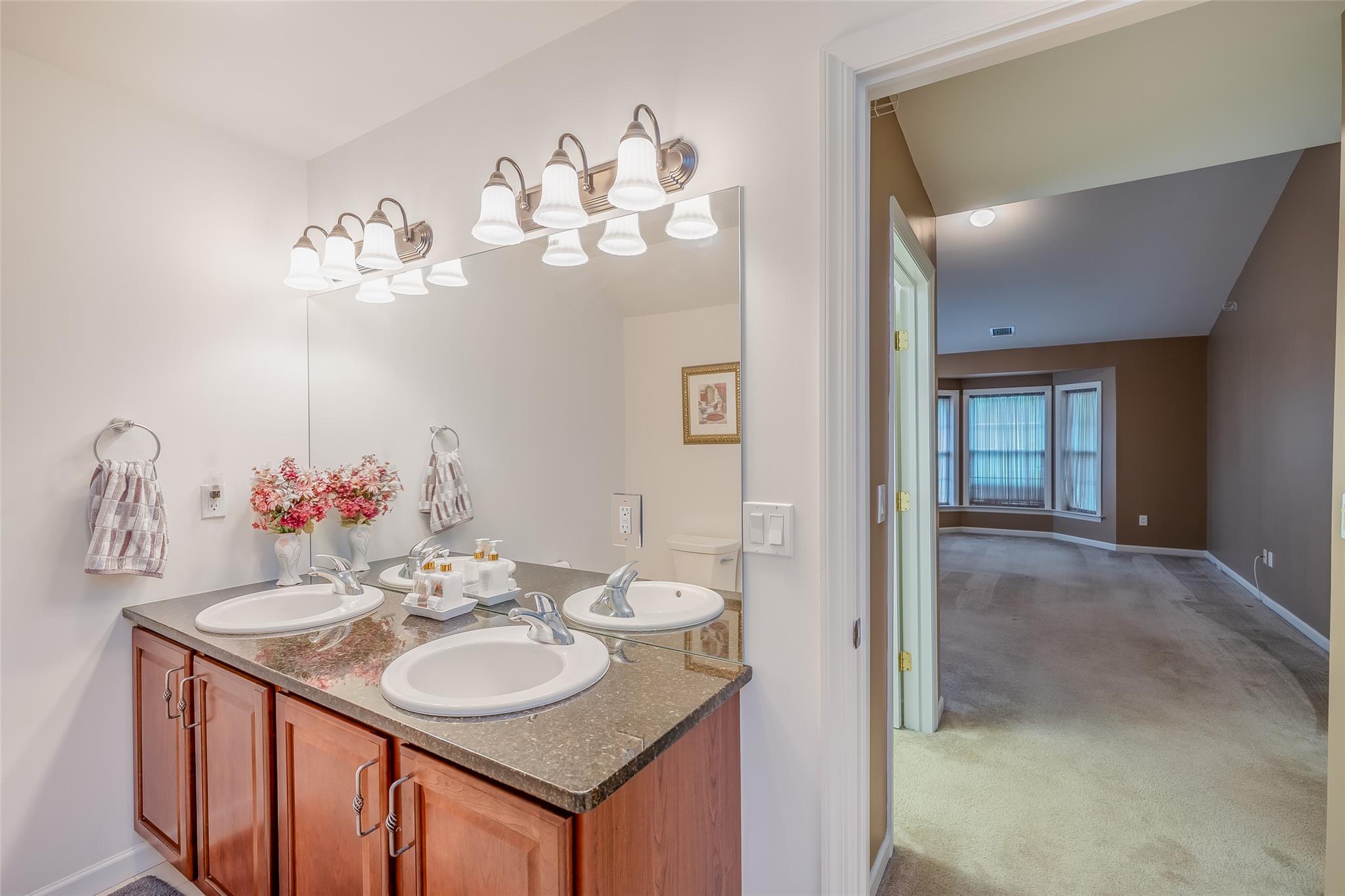 166 Ira Road Mount Sinai, NY 11766 - Photo 22 of 37 a bathroom with a sink vanity and a mirror