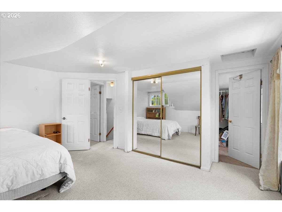 772 Division Street Oregon City, OR 97045 - Photo 14 of 47 a bedroom with a white bed and white walls