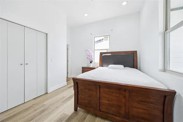a bedroom with a bed and a window
