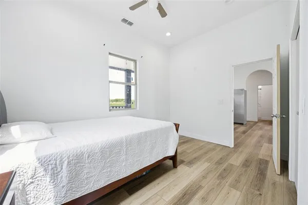 a bedroom with a bed and a window