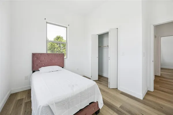 a bedroom with a bed and a window