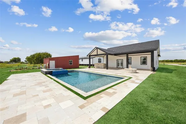 a front view of house with yard and entertaining space