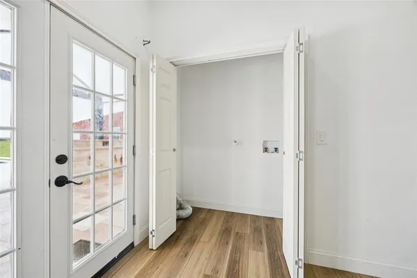 a view of a bathroom with wooden floor and windows
