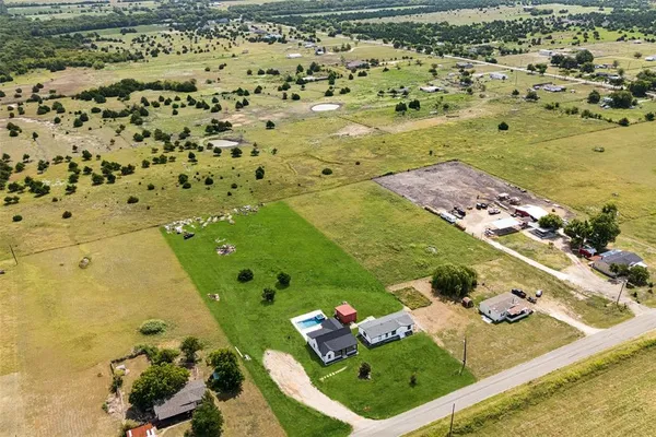 an aerial view of a house with pool ocean view