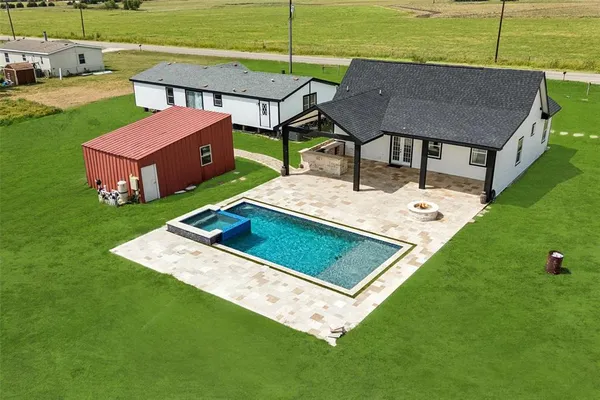 a view of a backyard with sitting area