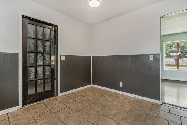 a view of a room with a ceiling fan and a window