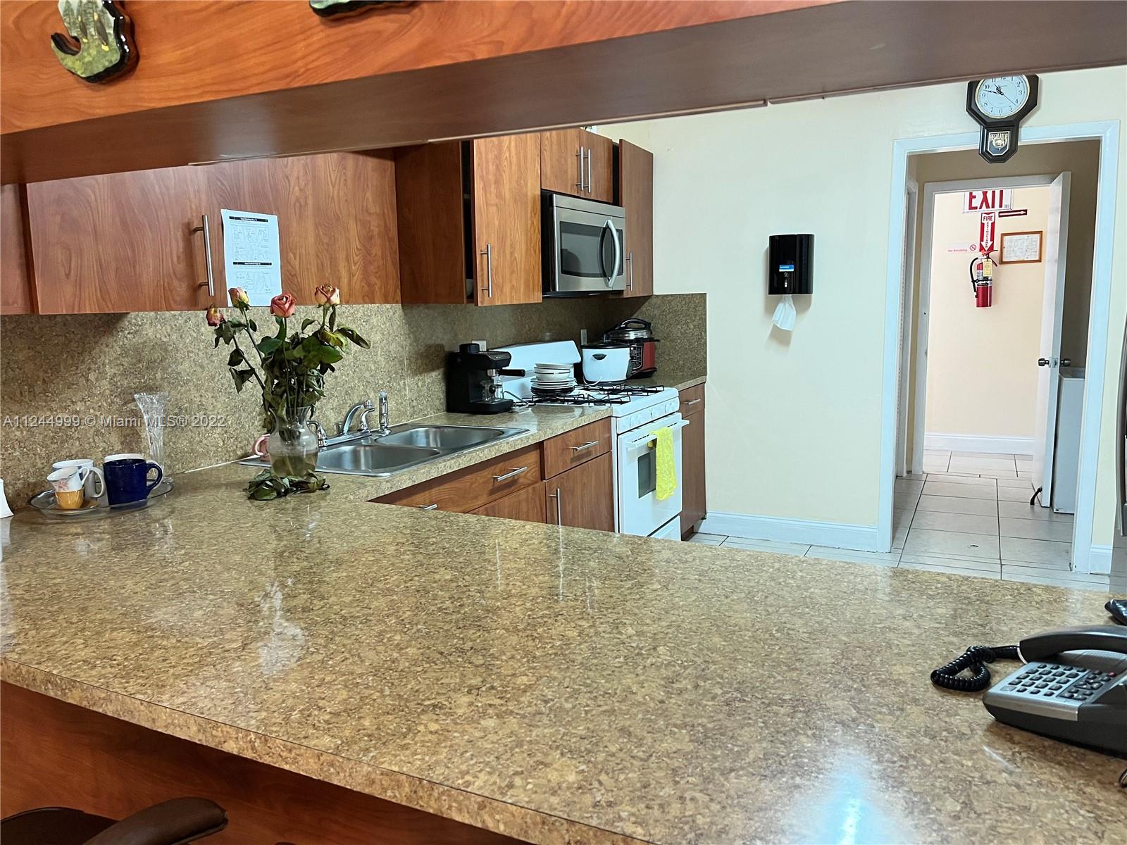 2520 Southwest 102nd Avenue Miami, FL 33165 - Photo 11 of 21 a kitchen with kitchen island a sink stainless steel appliances and counter space