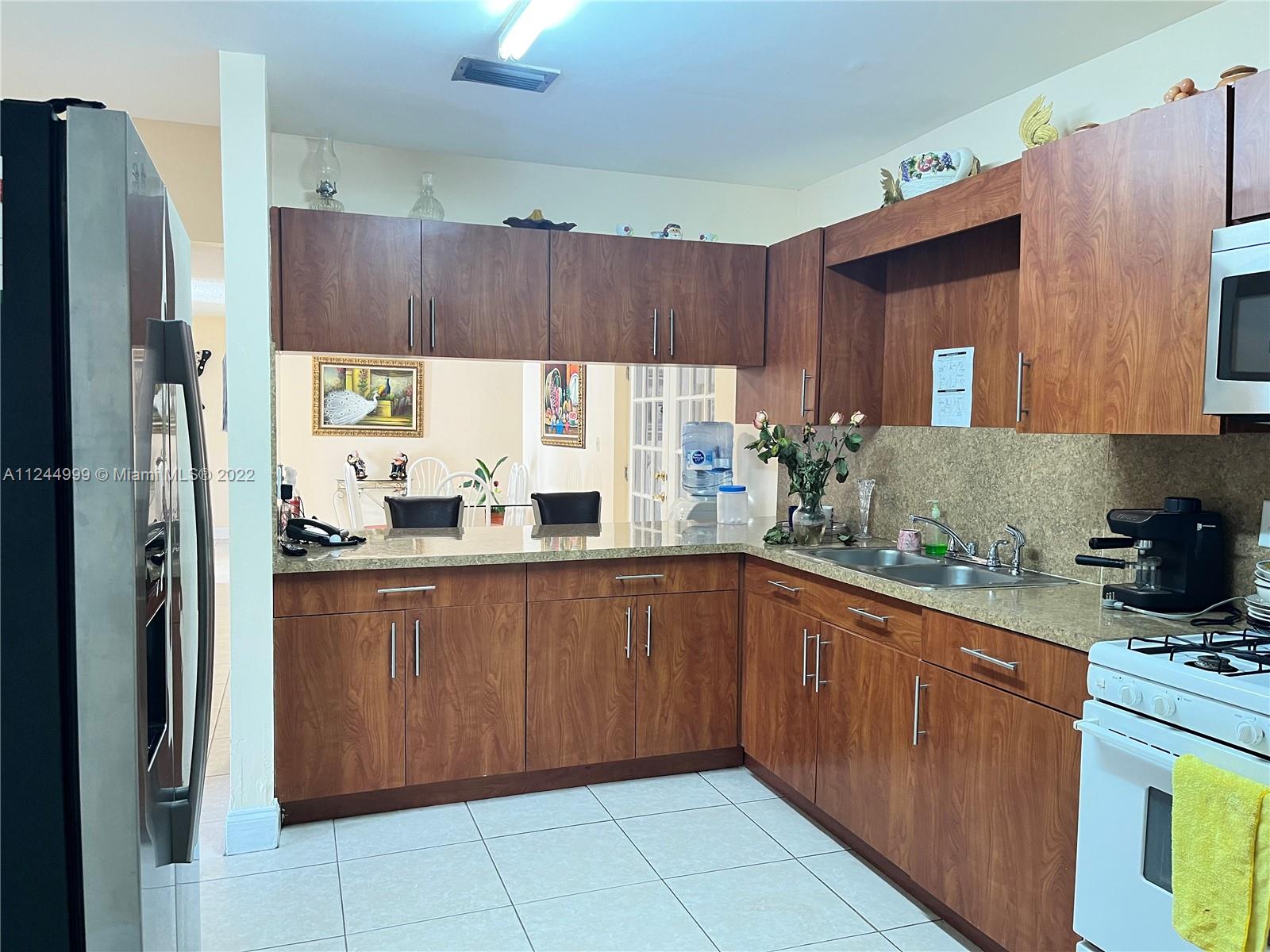 2520 Southwest 102nd Avenue Miami, FL 33165 - Photo 12 of 21 a kitchen with stainless steel appliances granite countertop a refrigerator and a sink