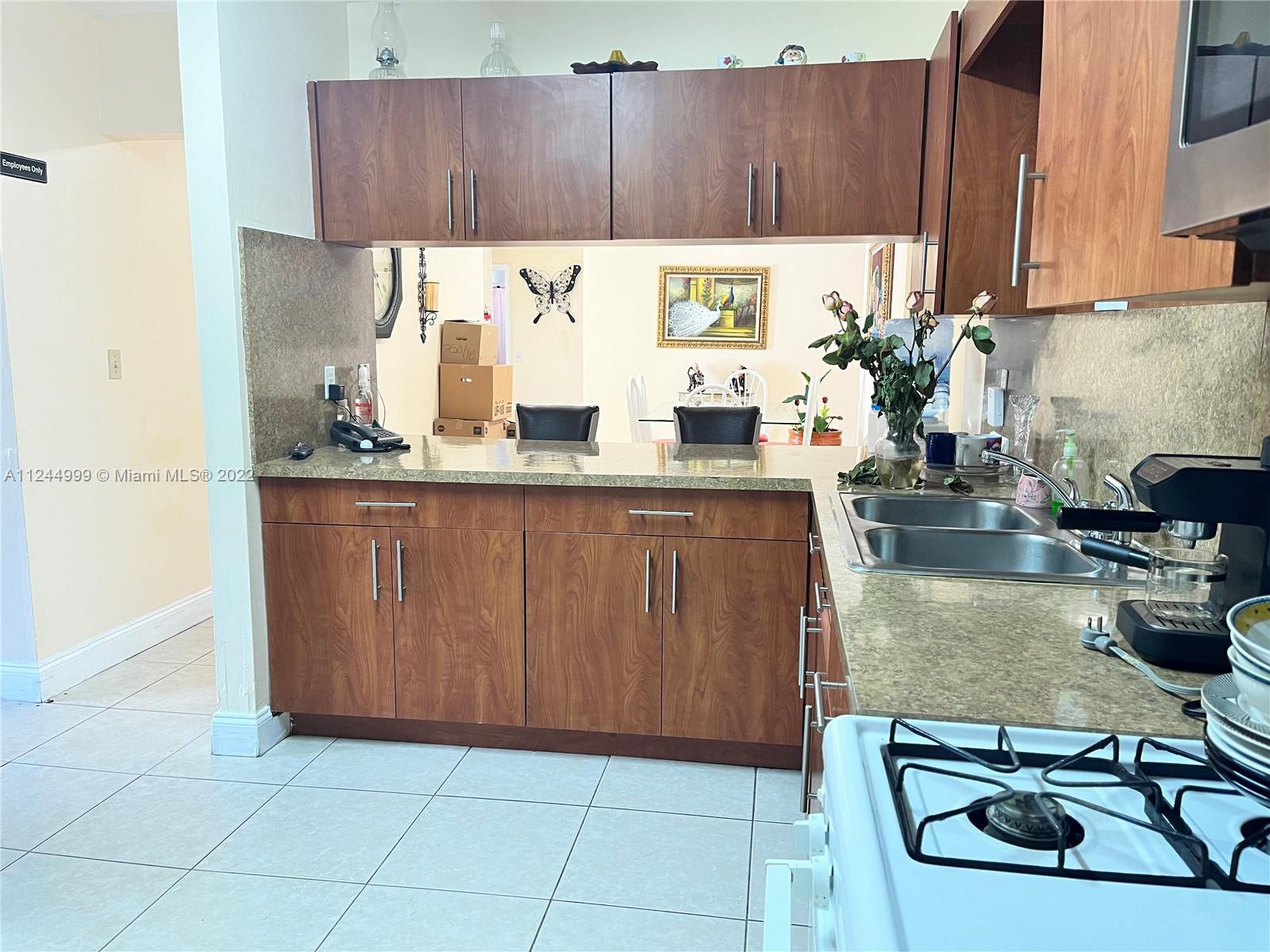 2520 Southwest 102nd Avenue Miami, FL 33165 - Photo 13 of 21 a kitchen with wooden cabinets and a sink