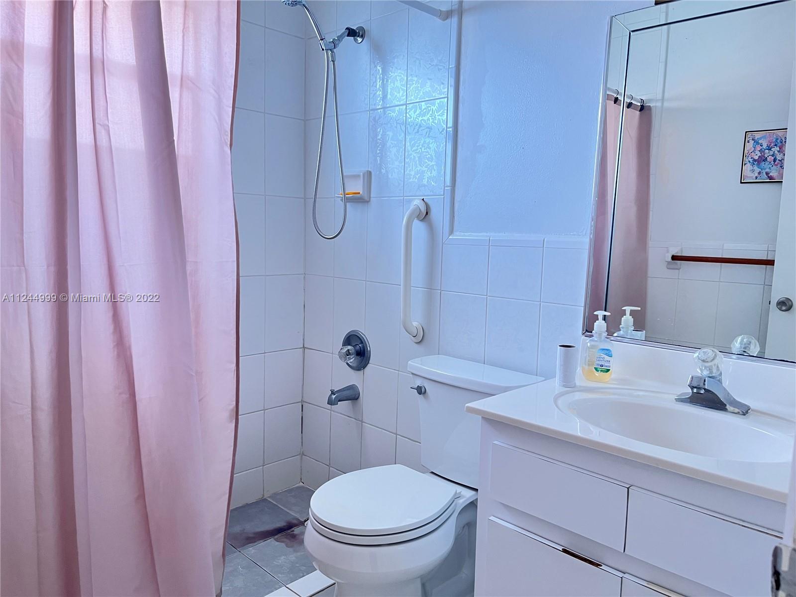 2520 Southwest 102nd Avenue Miami, FL 33165 - Photo 18 of 21 a bathroom with a sink a toilet and shower curtain