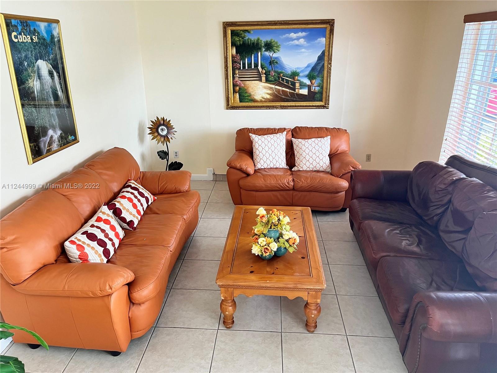 2520 Southwest 102nd Avenue Miami, FL 33165 - Photo 6 of 21 a living room with furniture and a painting on the wall