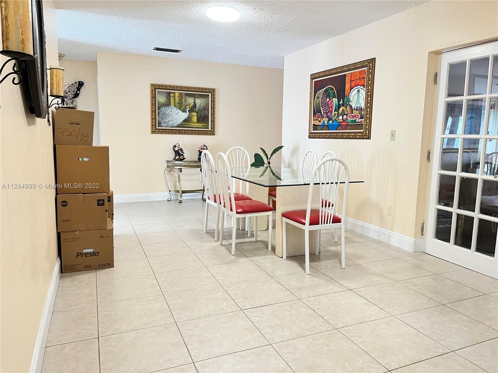 2520 Southwest 102nd Avenue Miami, FL 33165 - Photo 10 of 21 a living room with furniture and wall paintings