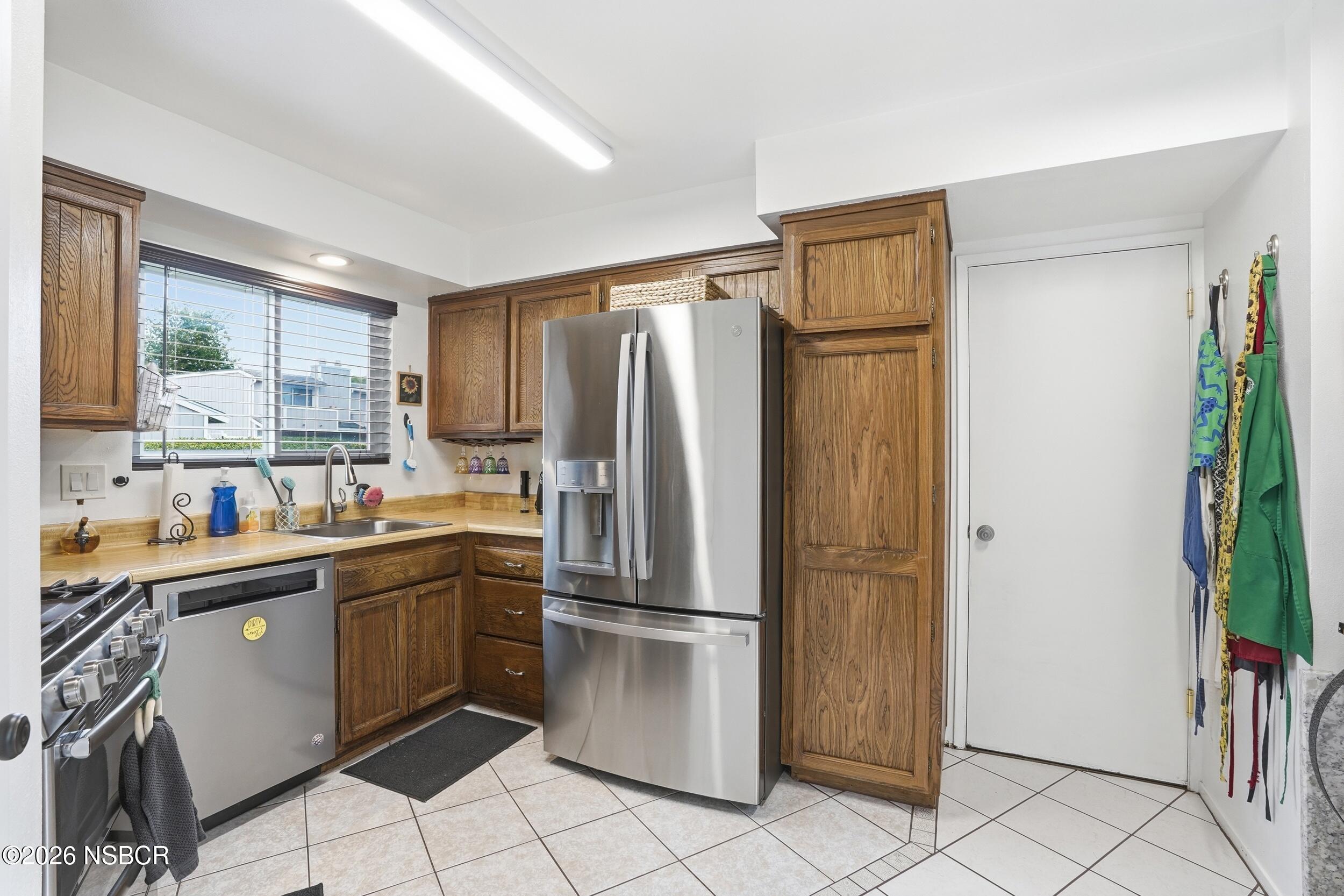 218 North R Street Lompoc, CA 93436 - Photo 13 of 24 a kitchen with stainless steel appliances granite countertop a refrigerator and a sink